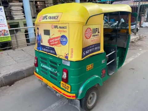 Auto-rickshaw with branded hood and panels