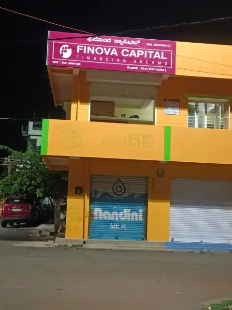 Shop front with front-lit board and shutter branding